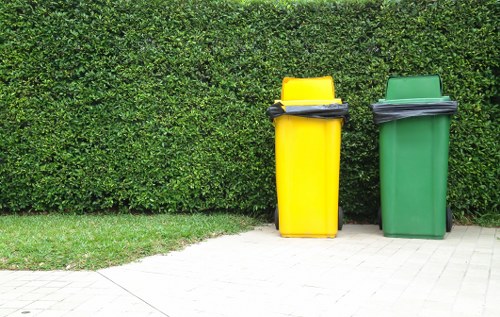 Professional gardeners collecting garden waste